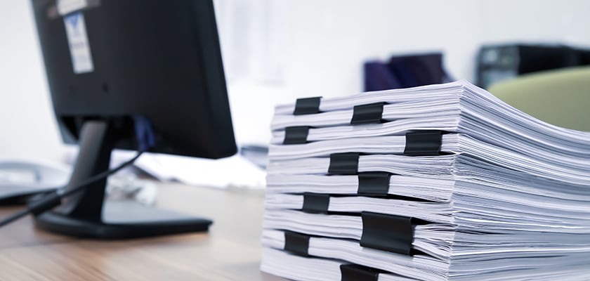 A work desk full of paper documents